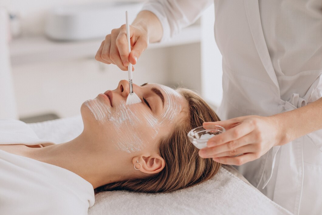 cosmetologist doing face treatment applying face mask 1303 28042